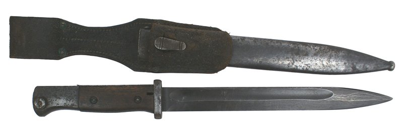 German WWII K-98 bayonet: D-92 German WWII K-98 bayonet-with wood grips. Finish has patches of light pitting, as does the scabbard. Blue-gray blade marked "jwh" and "4529". Mismatched scabbard. Well-worn leather frog-marked "K