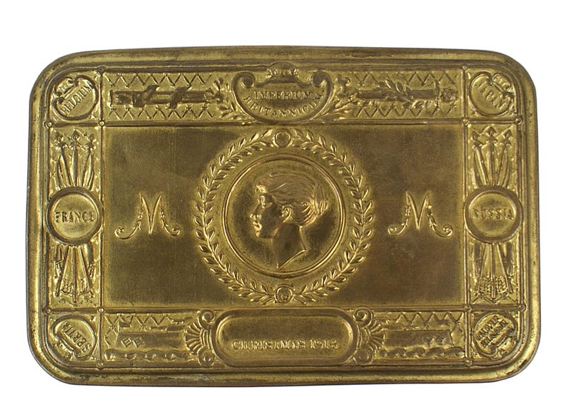 British WWI Princess Anne Christmas tin: H-182 British WWI Princess Anne Christmas gift biscuit tin. Brass, with a relief portrait of the Princess, names of the Allies and "Christmas 1914". 5 1/8" x 3 3/8" x 1 1/4". II