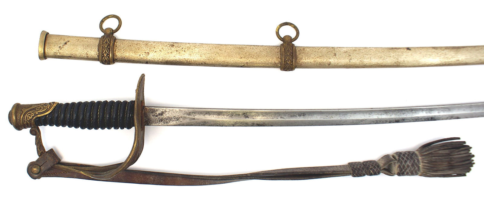 US M1872 Cavalry Officer sword: K-056 US M1872 Cavalry Officer's sword. Oak leaf decorated pommel, three-branch knuckle-bow/guard with an eagle/stars. With a leather portopee. 30 1/8" curved blade - graying with black spotting. Nick