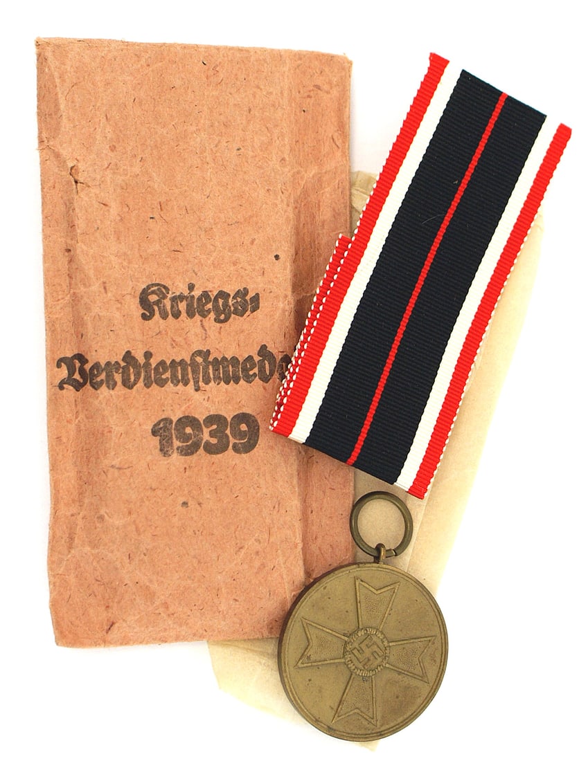 German WWII KvK War Merit Medal: B-035 German WWII KvK (War Merit Medal). Bronze - swastika on a Maltese Cross. With ribbon, tissue and packet envelope (maker marked - "Richard Simm & Sohne - Gablonz/Reise". II+