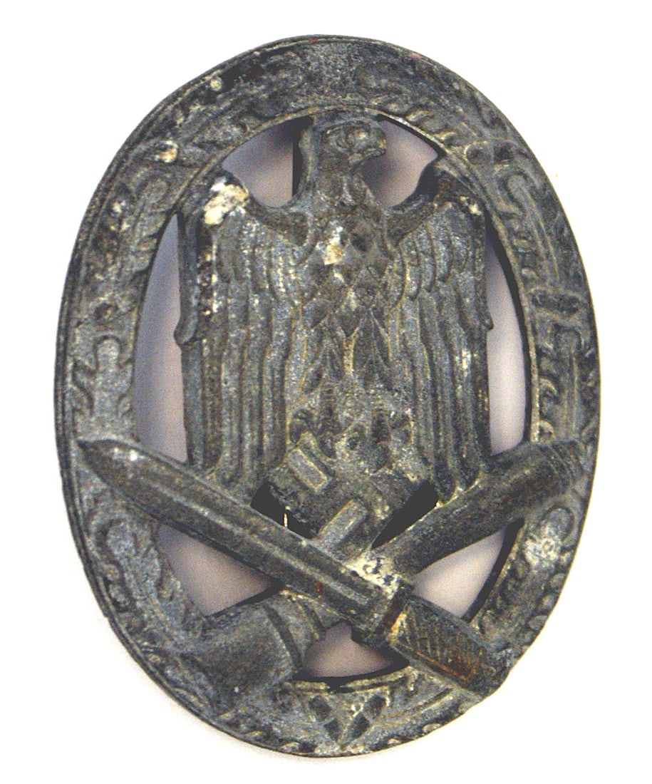 German WWII Army Waffen SS General Assault Badge: B-040 German WWII Army and Waffen-SS General Assault Badge. Eagle/swastika and crossed stick grenade/bayonet on an open oak leaf wreath. Heavy wartime issue has turned gray from age. Vertical round pi