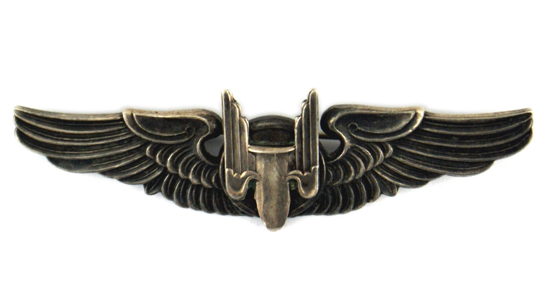 US WWII Army Air Force Aerial Gunner wings: B-072 US WWII Army Air Force silver Aerial Gunner wings. Relief winged projectile in center. Reverse marked "STERLING"/"WOODY BROS. L.A. CALL". Also engraved with name of owner "C.O. COOKE Jr. - 1317.
