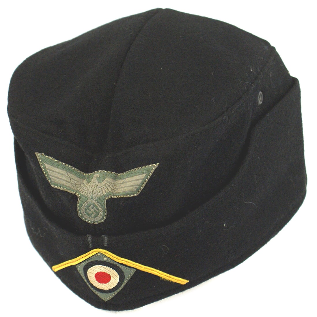 German WWII Panzer EM NCO oseas cap: E-062 German WWII Panzer EM/NCO o'seas cap. Fine black "doeskin" material. Gray on green bevo embroidered eagle/swastika and rosette under yellow-gold soutache (Cavalry). Gray lining is stamped with n