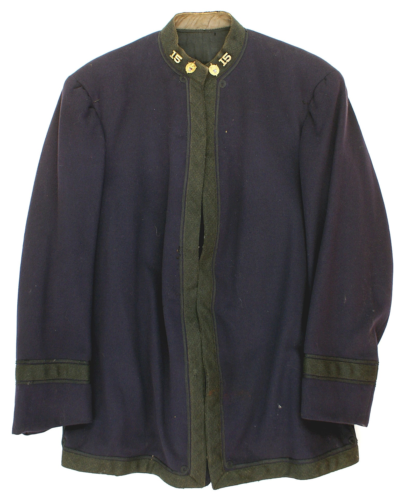 US Coast Guard tunic/peaked cap M1877: F-028 US early 20th Century Coast Guard tunic and peaked cap. M 1877 black pocketless tunic with black mohair 1" wide piping and stand up collar. Gilt pin-on collar insignia - eagle/"CG" and "15". Sho