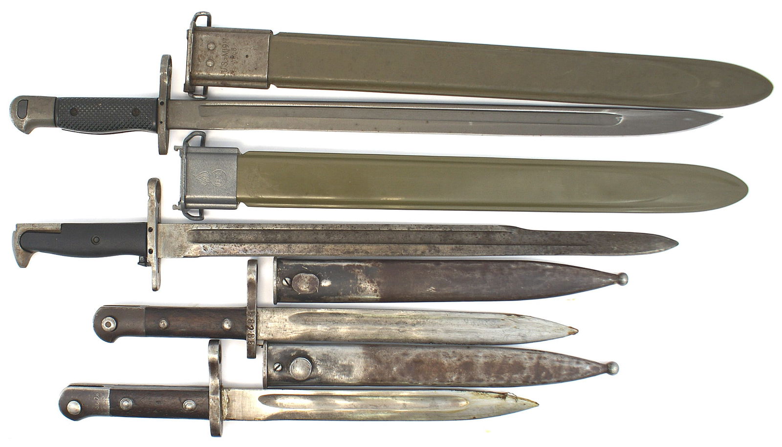 Lot of 4 bayonets Turkish M1935 US: D-063 Lot of 4 bayonets: (1) Two Turkish Sungo M1935 bayonets. 9 3/4" gray blade. Wood grip with a steel pommel and crossguard/muzzle ring. Both marked with "ASFA" and a serial number. Blackened steel