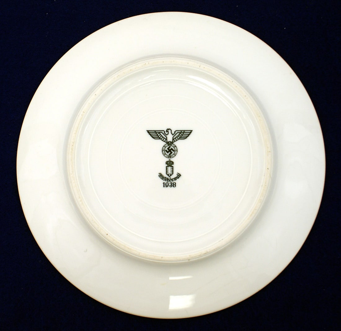 German WWII NSDAP mess hall porcelain plate: H-060 Third-Reich N.S.D.A.P. affiliate mess hall porcelain dinner plate. 9 1/8" diameter. Reverse has an eagle/swastika over a crowned pine tree shield and "Altschonwald 1938". From the Donald G. Brow