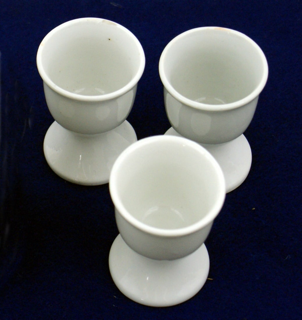 3 German WWII messhall egg cups: H-063 Lot of 3 German messhall egg cups. White porcelain. Under side marked with eagle/swastika over "M". II