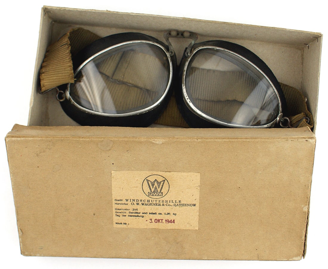 German WWII boxed military goggles: N-004 German WWII boxed military goggles. Clear lenses in metal frames with rubber borders and a double elastic strap. Paper label on box top with makers logo "W" over "OWA" (O.W. WAGENER & CO.) AND D