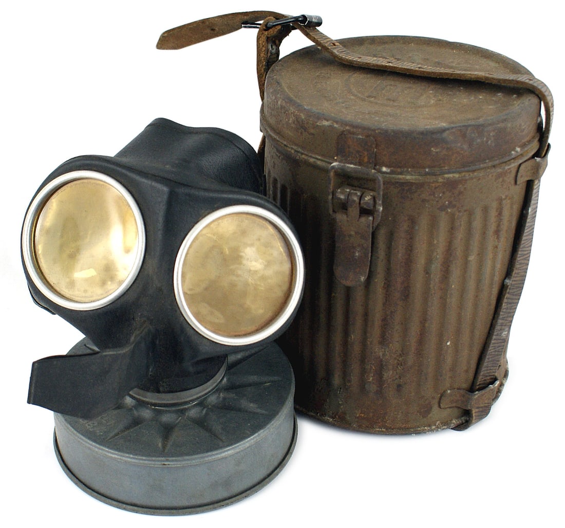 German WWII Luftschutz Civil type gas mask: N-010 Luftschutz/Civil type gas mask. Rubber mask marked with eagle/swastika/etc. as is the metal "pancake" filter. Lenses intact. 7 1/8" high metal canister shows age and rust. With leather strap. II