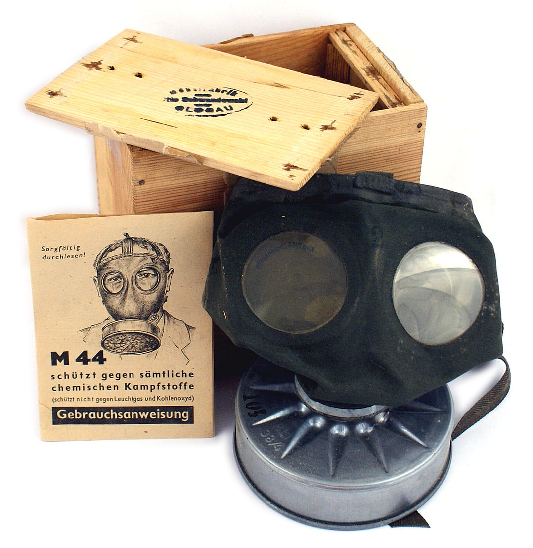 German WWII Civilian M44 gas mask: N-011 Civilian M44 gas mask. Rubber face mask with celluloid lenses and metal "pancake" filter. With eagle/swastika stamping. Also illustrated instructions - with original issue wood box. Ink stamped 