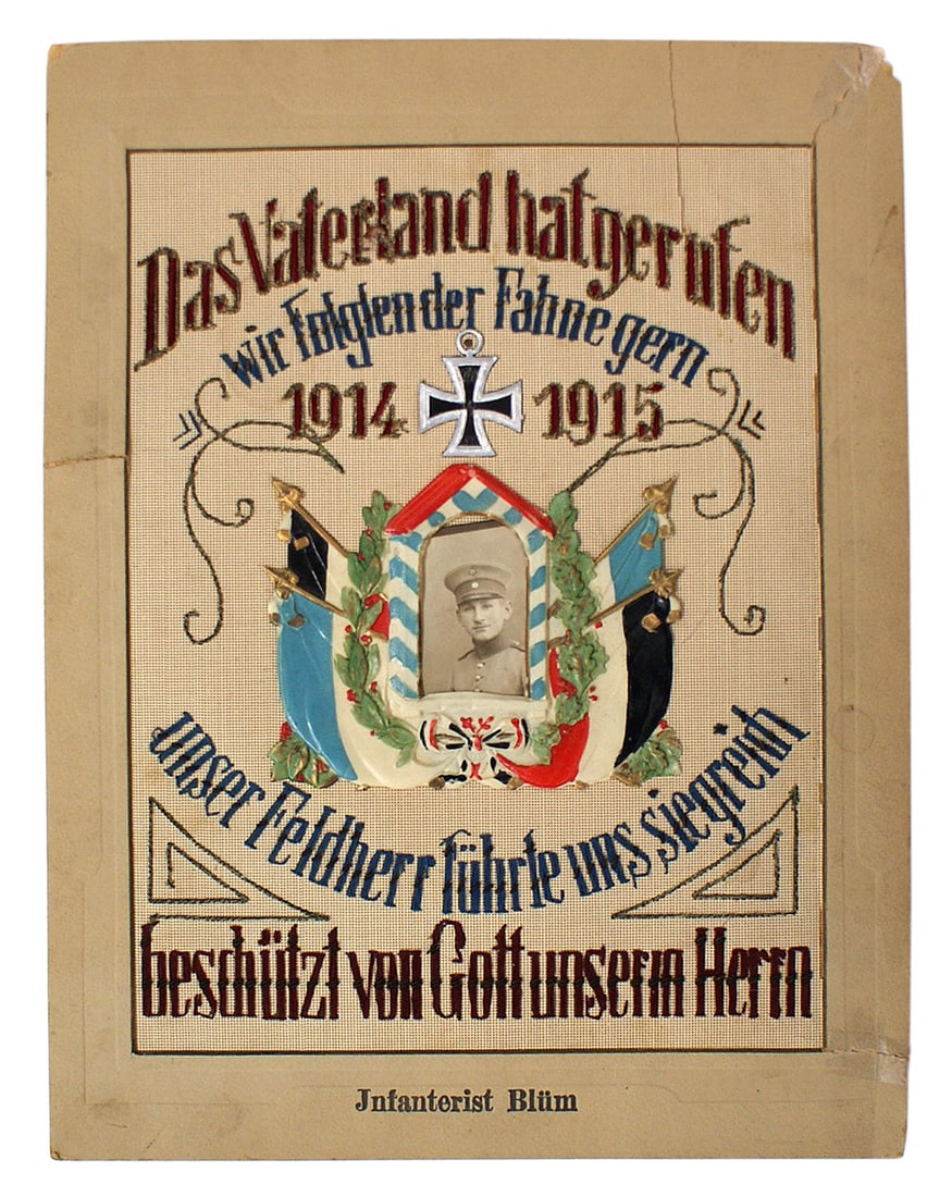 German WWI patriotic embroidery: G-008 German WWI patriotic embroidery. Finely perforated tan backing with colorful worded slogans and relief 1914 Iron Cross between "1914 - 1915". Center has a 5 1/2" x 6 3/4" color celluloid frame o