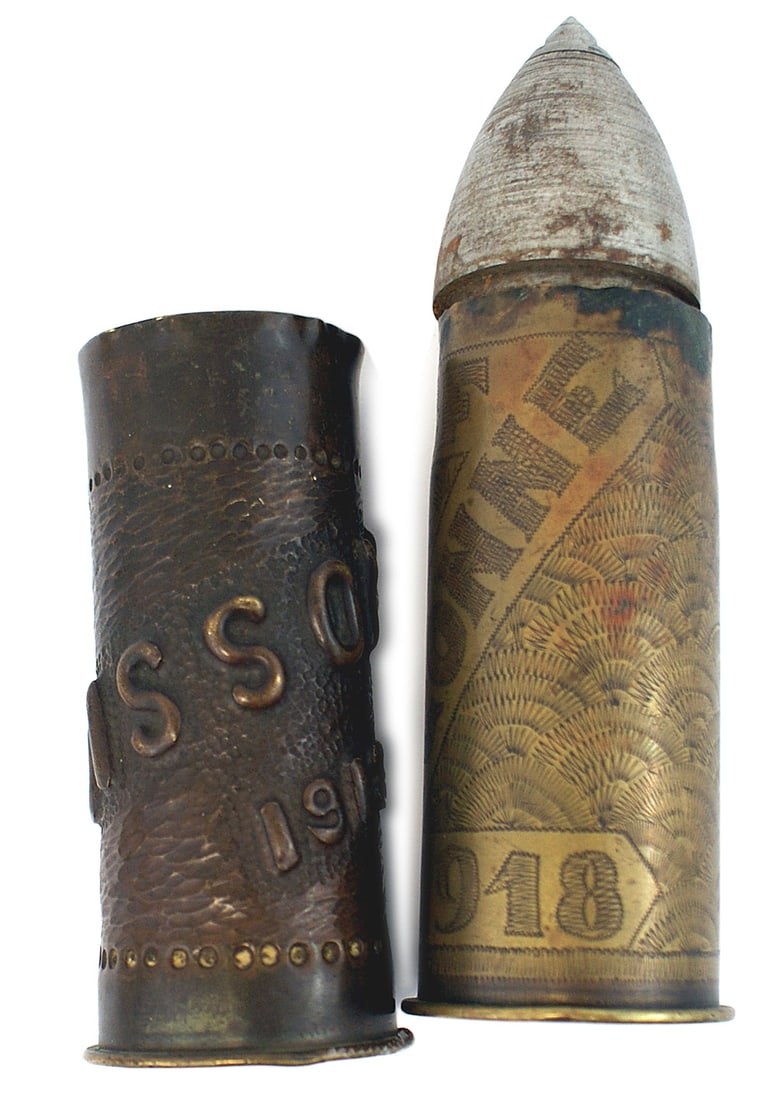 2 US trench art decorated French WWI shells: G-027 Lot of 2 U.S. "trench art" decorated French WWI brass shells: (1) Relief decorated "SOISSONS" in an upward path around the shell. Also with a large daisy and "1918". Top of shell circumference i