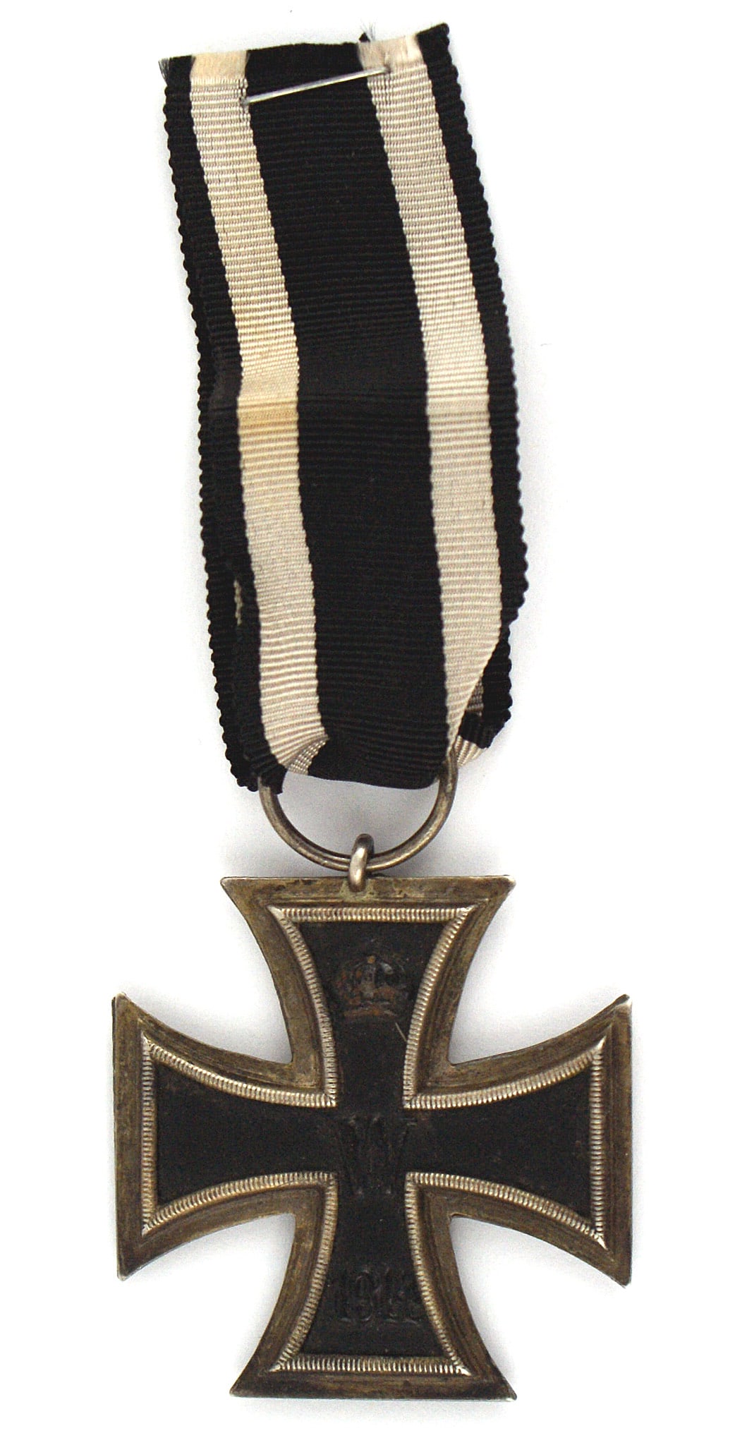 German WWI Iron Cross 2nd Class: B-013 German WWI Iron Cross 2nd Class. Black cross with a relief crown, "W" and "1914". Reverse with a crown, oak leaves and "1813". Silvered frame is darkened from age. With a proper ribbon. II