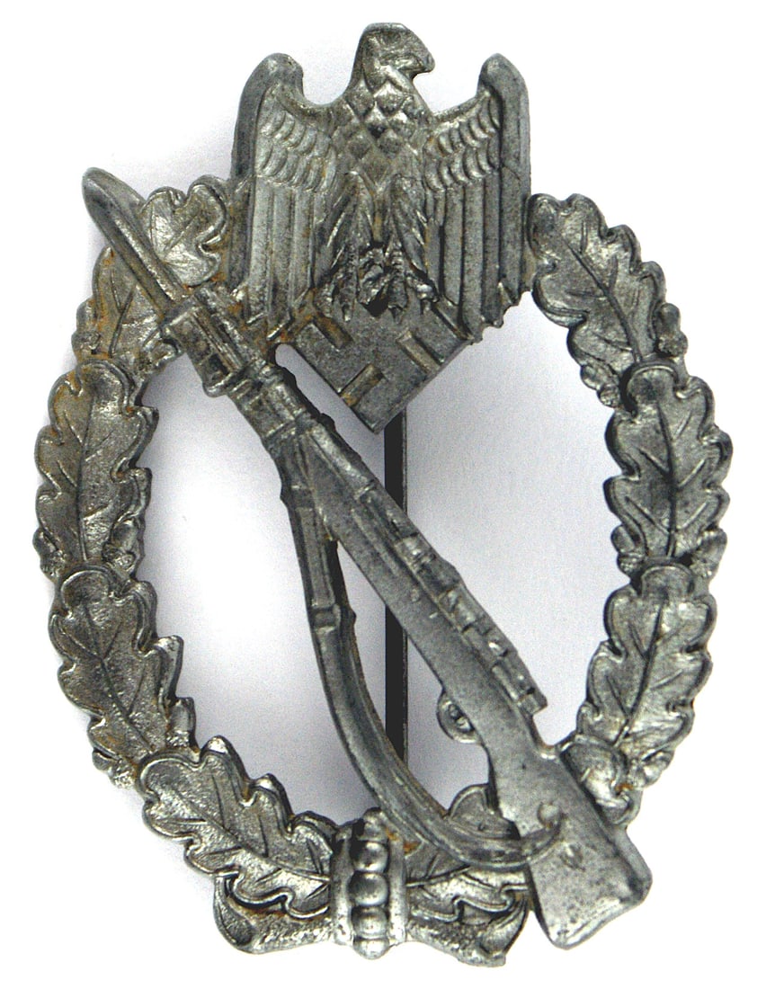 German WWII Infantry Assault Badge Silver: B-055 German WWII Army and Waffen SS Infantry Assault Badge - Silver. Rifle with fixed bayonet on an open leaf wreath and eagle/swastika at the top. Slightly convex. Solid II