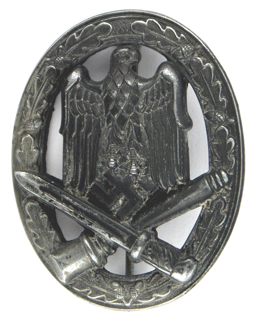 German WWII General Assault Badge Silver: B-057 German WWII Army and Waffen-SS. General Assault Badge - Silver solid type. Eagle/swastika over a crossed bayonet and stick grenade on an open oak leaf wreath. Reverse marked in relief "FRANK & R