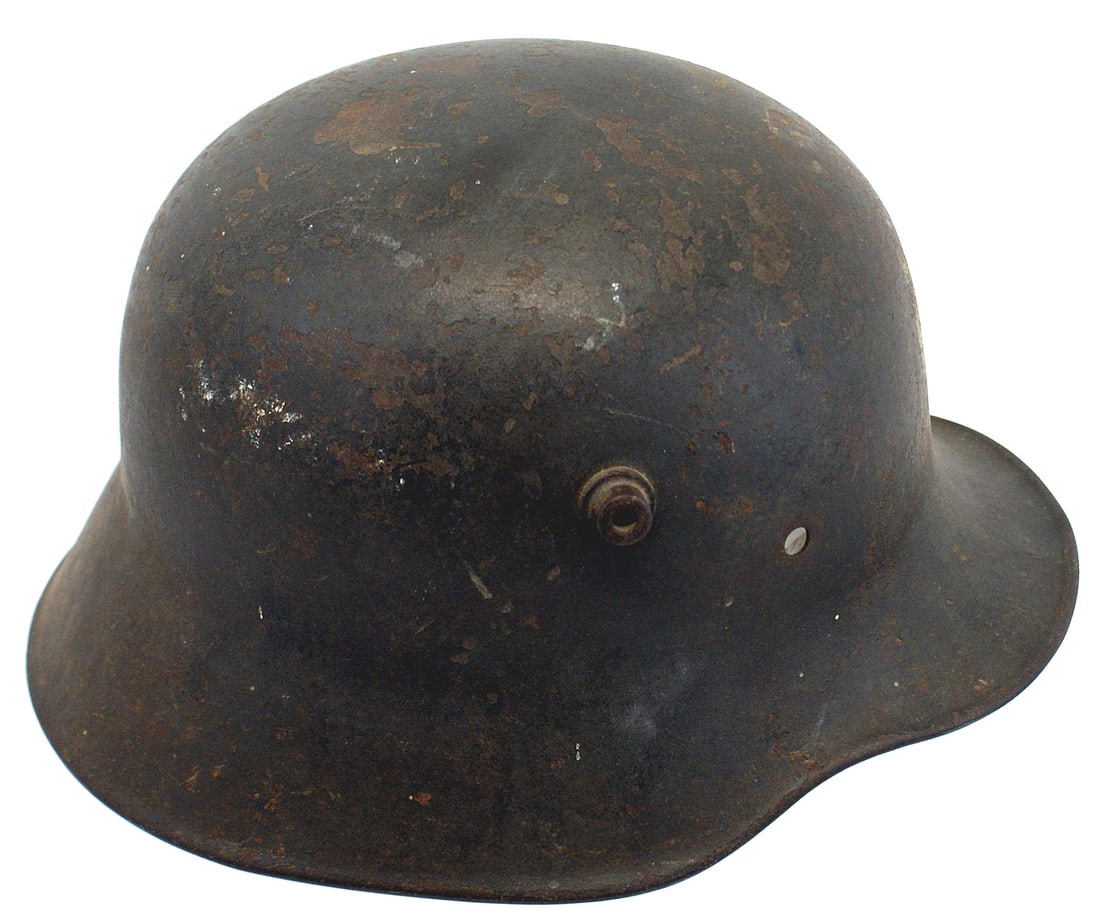 German WWI M1916 helmet: E-009 German WWI M1916 helmet. 85% of the original OD paint remains. Some small paint chips mainly on the top interior still has the original OD paint. Faint name of owner on underside of the back ski