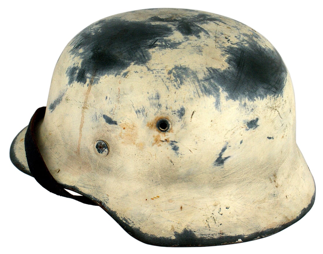 German WWII M1935 helmet SS decal added: E-021 Original German WWII M1935 helmet. A reproduction SS decal has been added along with a postwar application of white paint to create a winter used helmet. Leather liner and chinstrap are intact b