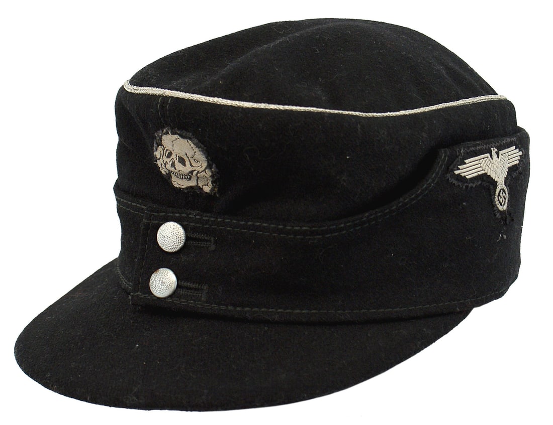 German WWII Waffen-SS Panzer M1943 field cap: E-051 German WWII Waffen-SS officers black Panzer M1943 field cap. Bevo embroidered skull on front and W - SS eagle/swastika on side of the turn-up "flap". Silver (aluminum) piping around crown. Visor