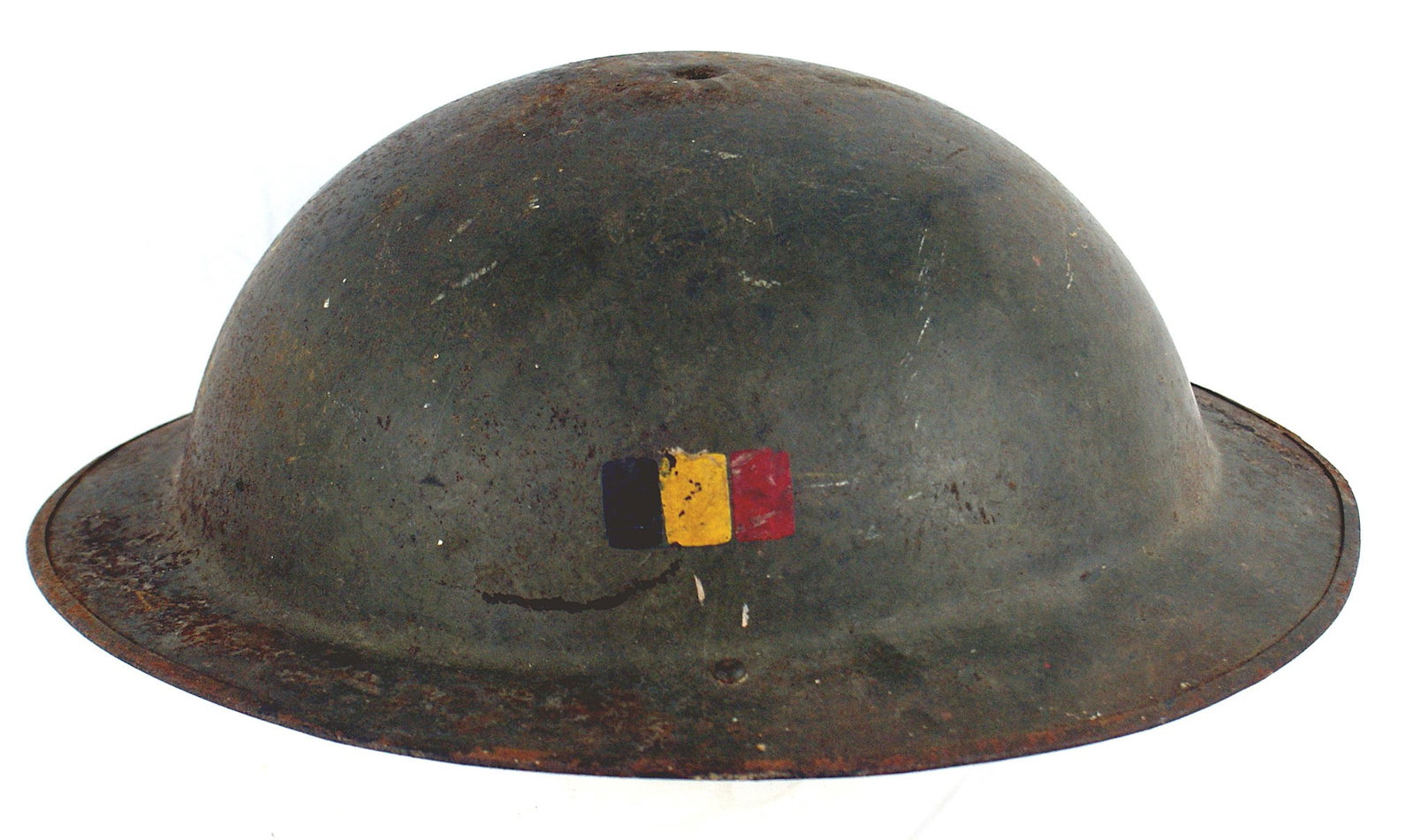 Belgian WWI helmet British type OD finish: E-065 Belgian WWI helmet. British type O.D. finish showing some wear. National colors black/yellow/red painted on left side O.D. web chinstrap. Missing liner and top center stud. II-