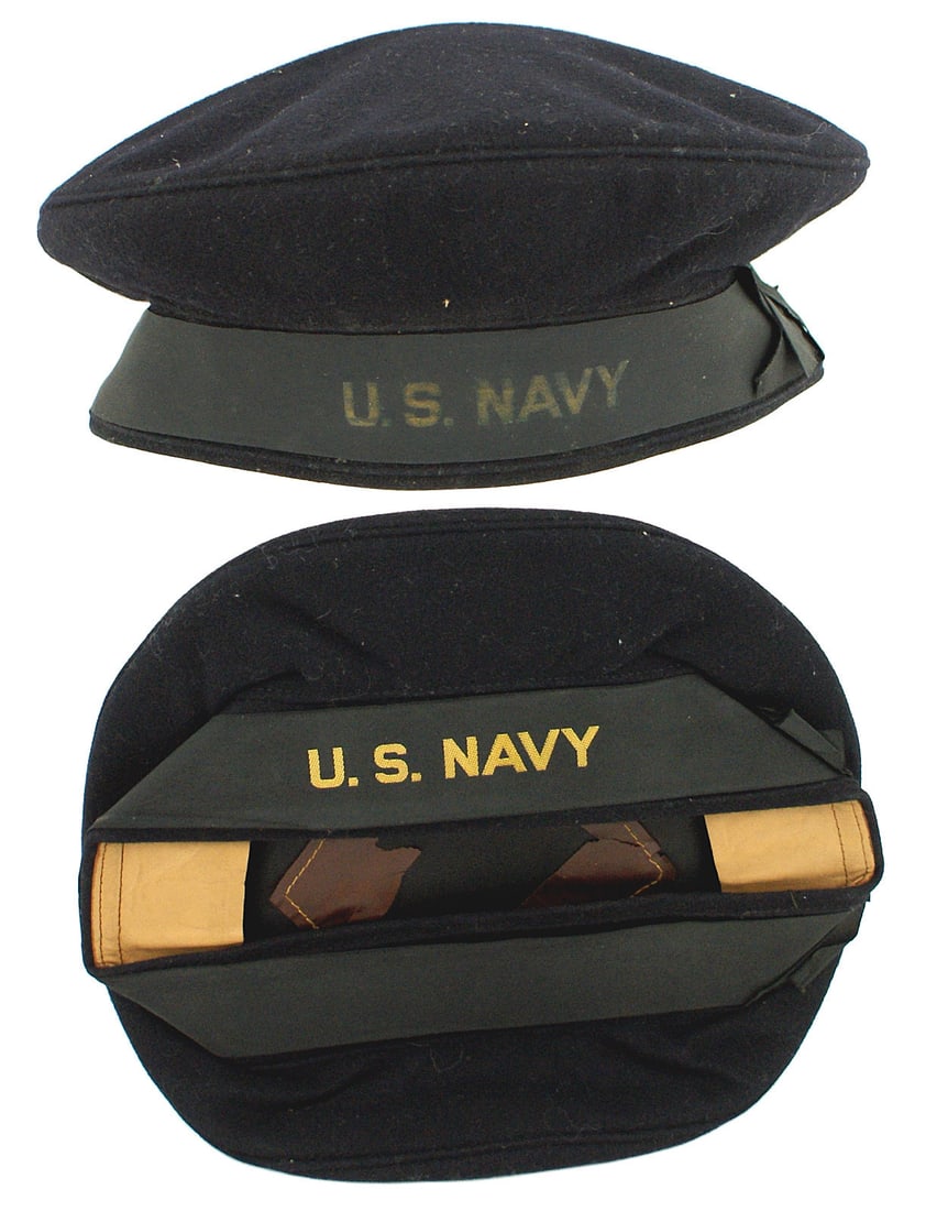 2 US WWII Navy Donald Duck caps: E-085 Lot of 2 US WWII Navy "Donald Duck" caps. Dark blue wool with gold embroidered "US Navy" on a black tally. Light tan leather sweatband and black lining. Both plastic moisture shields have deteri