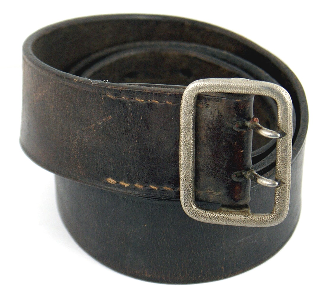 German WWII SA/SS used belt/buckle: F-011 German Third Reich SA/SS used dark brown leather belt. Stamped with "RZM" and "Kernftuel". Pebbled silvered, two-prong buckle - marked "RZM - UE - 54". Size 33. Shows wear but is solid. II