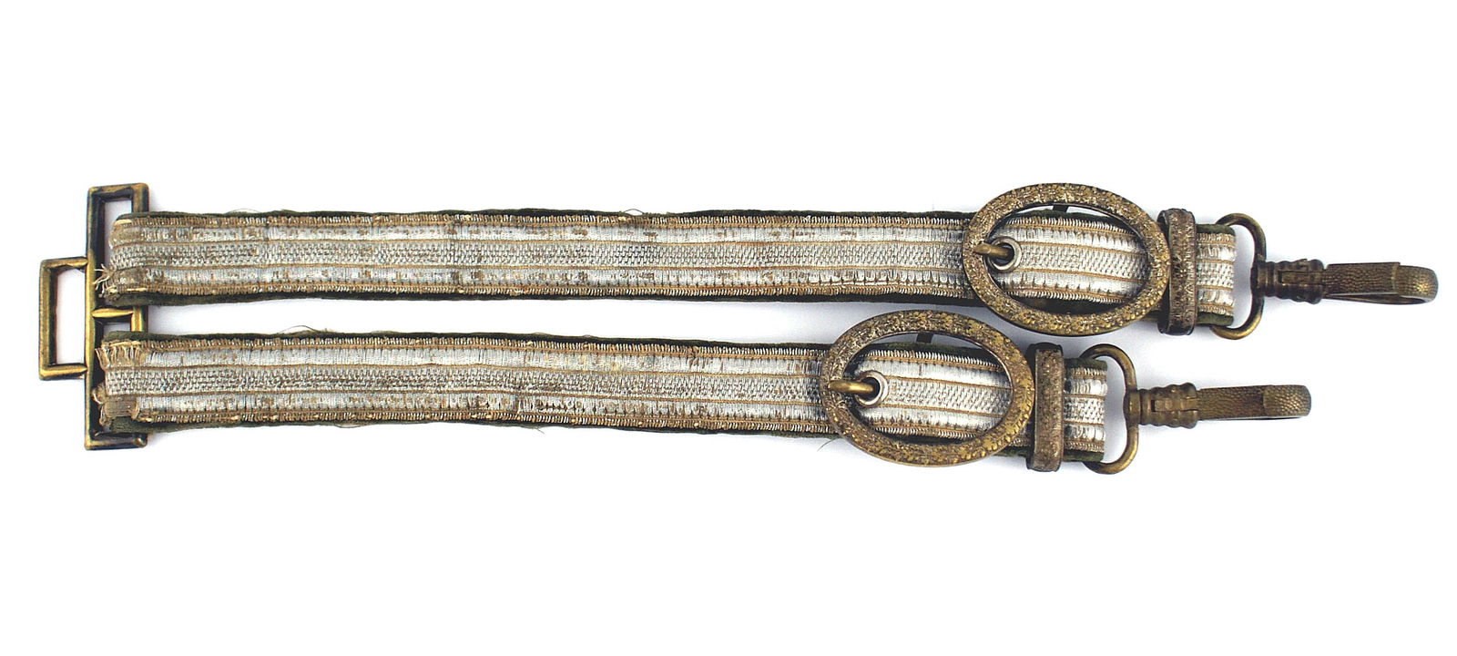 German WWII Army General dagger hangers: D-066 German Third-Reich/WWII Army General's dress dagger hangers. Vertical linear designs on the flat silver "tape" straps with green velvet backing. Age toned gold belt brace, oval buckles, slides a