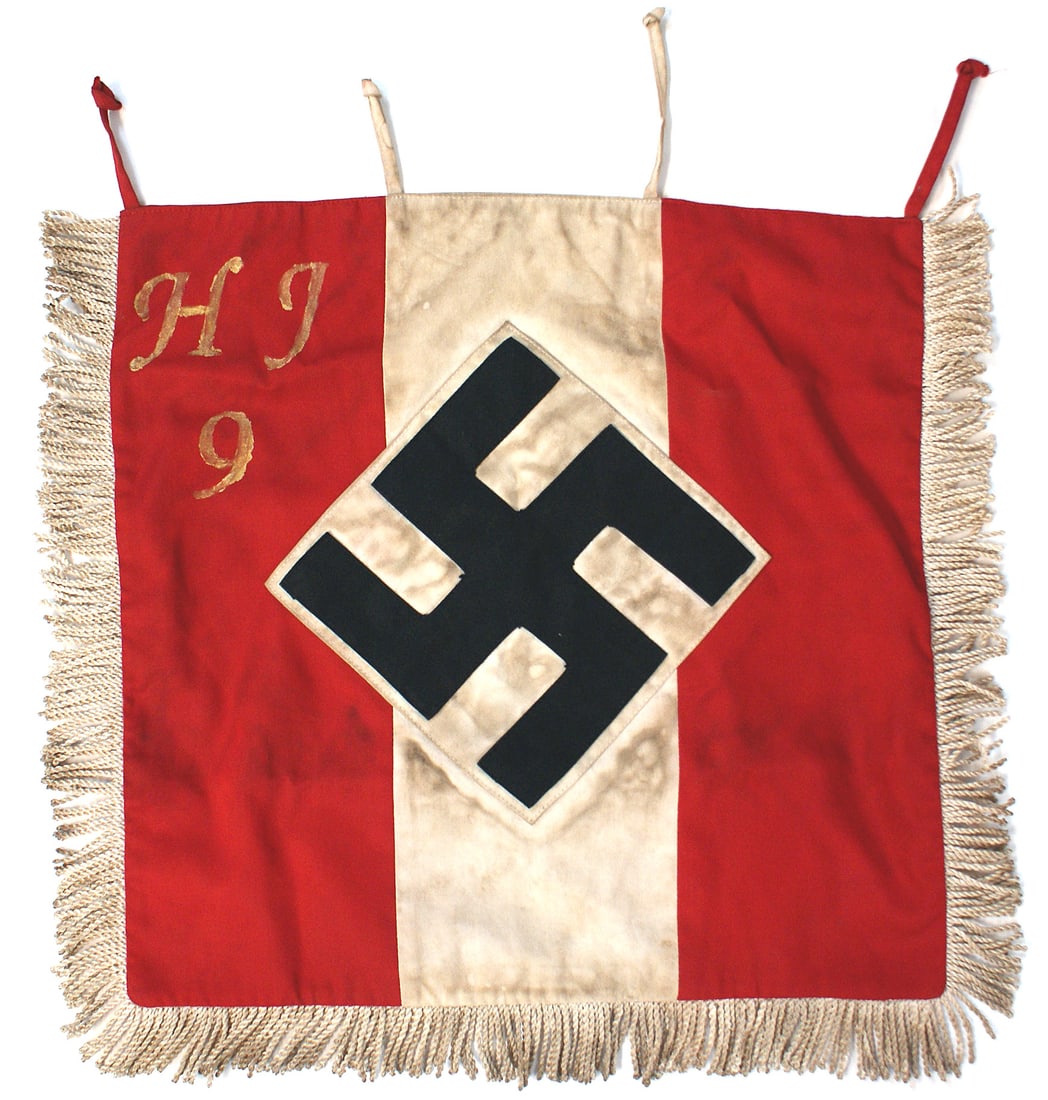German WWII Hitler Youth fanfare trumpet banner: H-068 Third-Reich Hitler Youth fanfare trumpet banner. Large black 7 1/2" x 7 1/2" tilted swastika sewn to a white cloth sewn to the 6 1/4" wide white center of the red field. Upper left corner painte