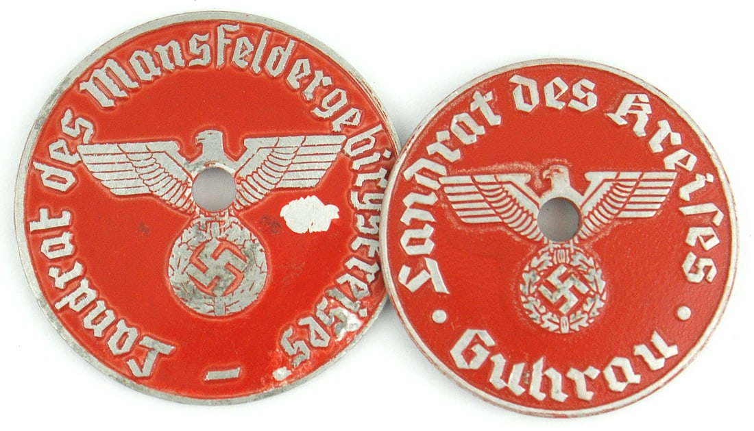 Lot of 2 German WWII bicycle tags: H-075 Lot of 2 German Third-Reich bicycle tags: (1) Round aluminum disc with a red finish excluding the cleaned lettering "Landrat des Kreises - Guhrau". Center has a drilled hole for attaching. (2) S
