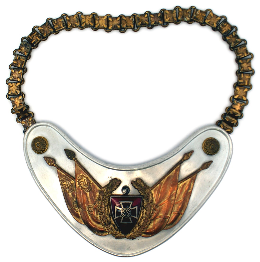 German WWII NS War Veterans gorget: H-085 German Third-Reich NS-RKB (National War Veterans Organization) gorget. White metal crescent with gilt relief floral bosses in top corners. A silver/black Iron Cross/swastika on a red enameled sh