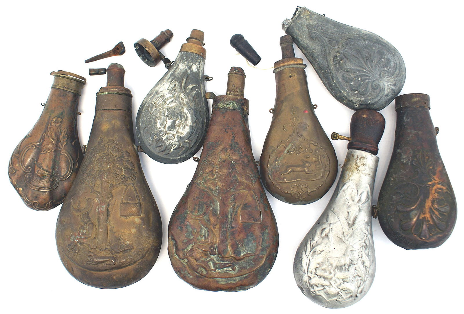 Lot of 8 antique powder flasks: M-034 Lot of 8 antique powder flasks. All are missing parts or damaged. Includes: (1) 5 3/4" zinc. High relief hound's head. (2) 6 1/4" darkened copper. Similar to above but floral pattern is inverted