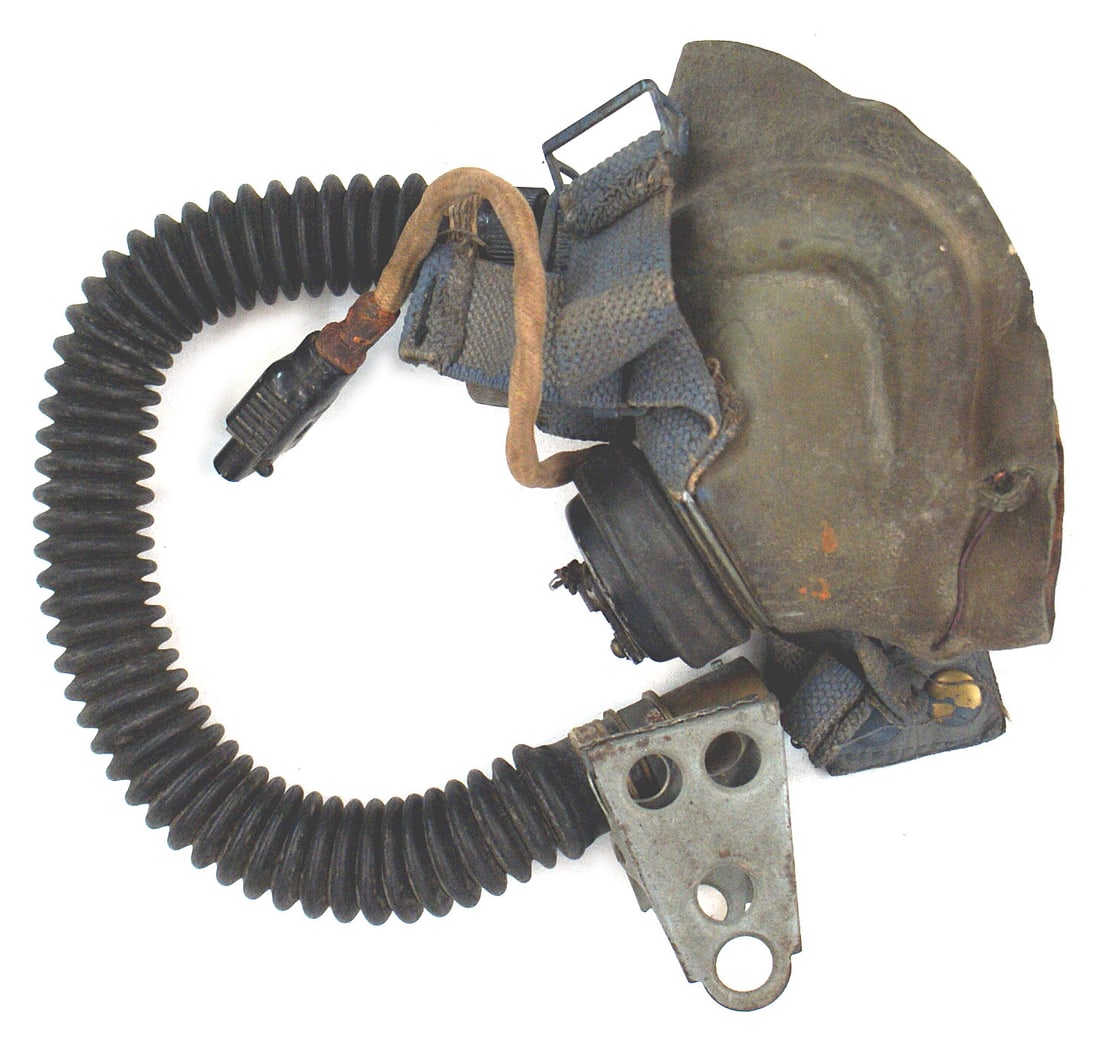 British WWII Royal Air Force oxygen mask: N-014 British WWII Royal Air Force oxygen mask. Rubber mouth piece with blue web straps. Flexible hose with a stabilizing clip, cord/jack and an oxygen control switch. Marked "BETACH. TMEE...". II