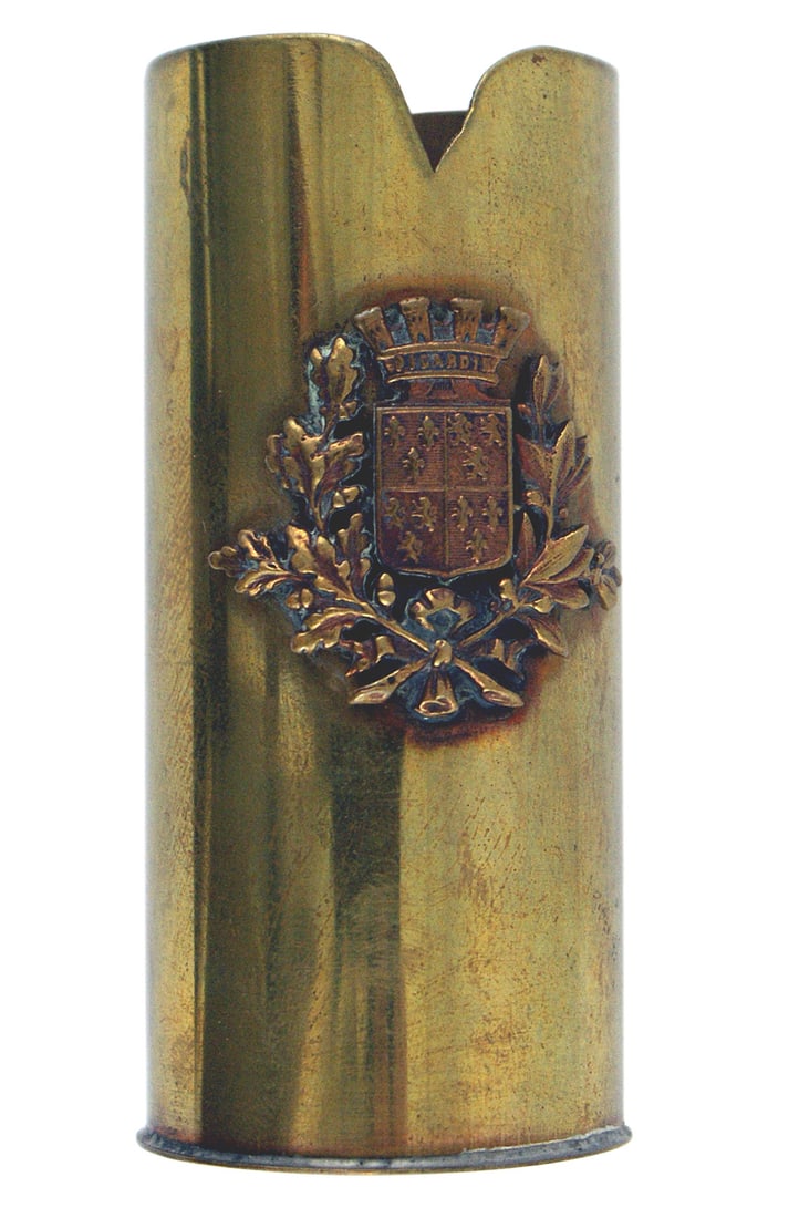 WWI British trench art shell casing: G-026 WWI British trench art. 3" brass shell casing with an applied coat of arms of the French coastal province of Picardie (crowned shield of fleur des lis and English lions within a wreath of oak le