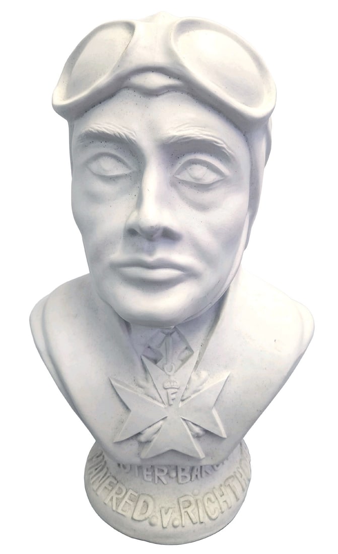 Bust German WWI ace von Richthofen Red Baron: G-031 Plaster bust of German WWI flying ace Manfred von Richthofen. 15" x 9 1/2" figure wearing an aviation helmet/goggles and an oversized "Pour le Merite" (Blue Max). Round base has raised lettering