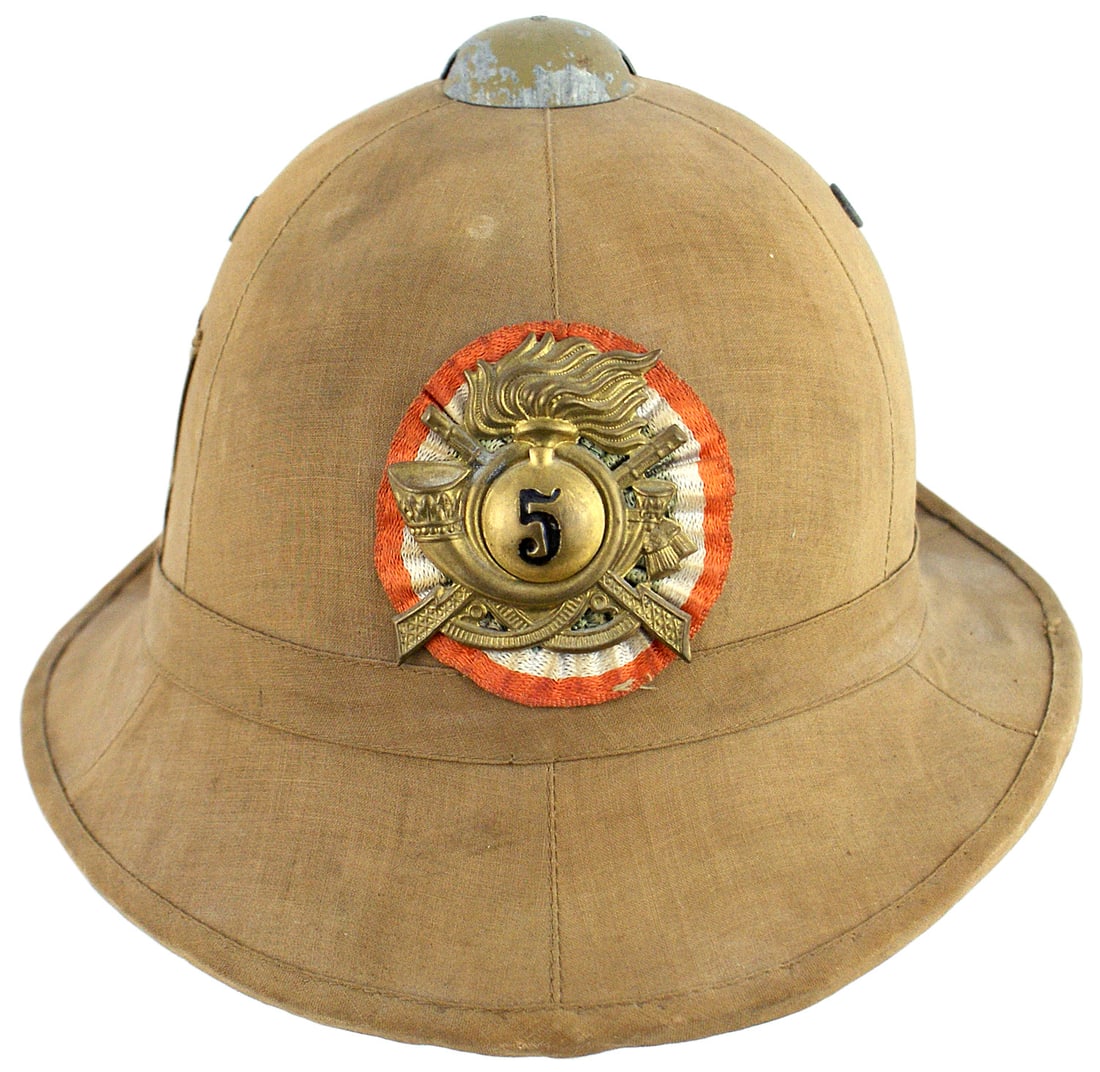 Italian WWII pith helmet: E-038 Italian WWII pith helmet. Tan cloth covered body with two screen air vents. Large age toned 5th Infantry Badge/National Colors ribbon sewn to front. Brown leather sweatband. Worn by Italian troo
