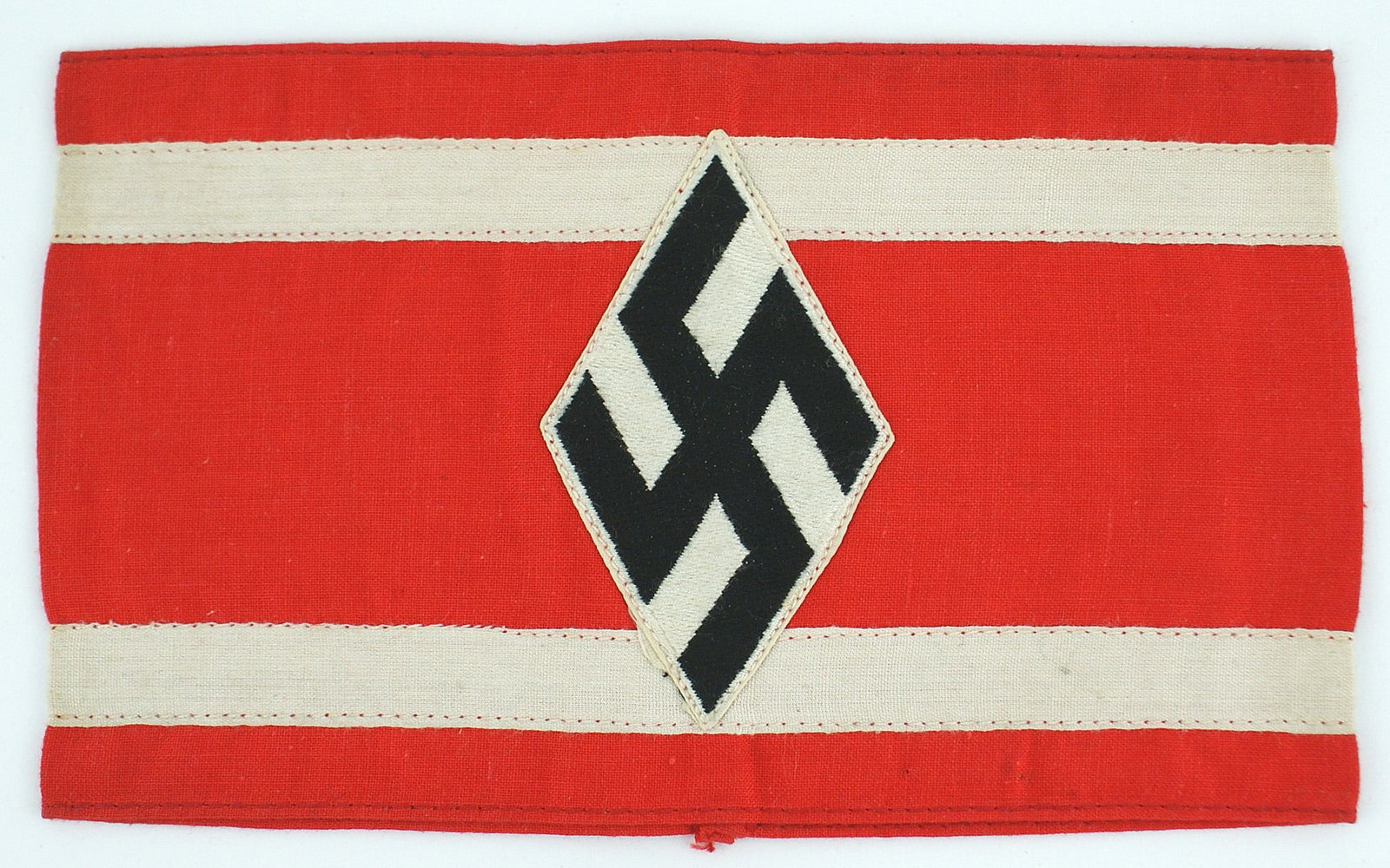German WWII Studentenbund armband: H-011 Third Reich Studentenbund armband. Diamond shaped black swastika on a white field sewn to a red band, with two white horizontal inner border stripes. Inside band has a paper "RZM" label. Excelle