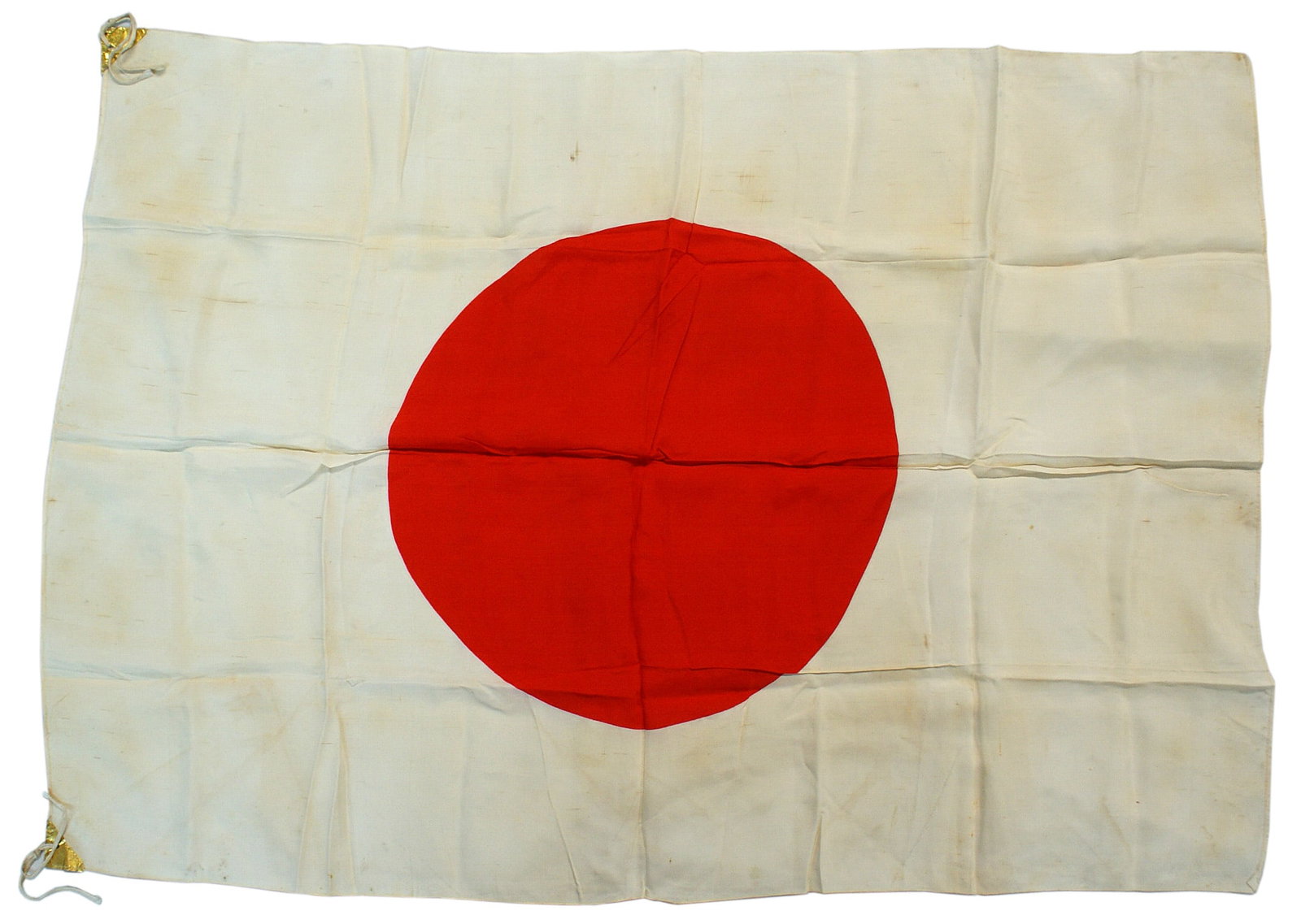 Japanese WWII silk meatball flag: H-093 Japanese WWII silk flag. 16" diameter red roundel in center of the 27" x 38" white field. Gold paper tabs in two corners with two white cord ties. Scattered small linear dried blood stains. A co
