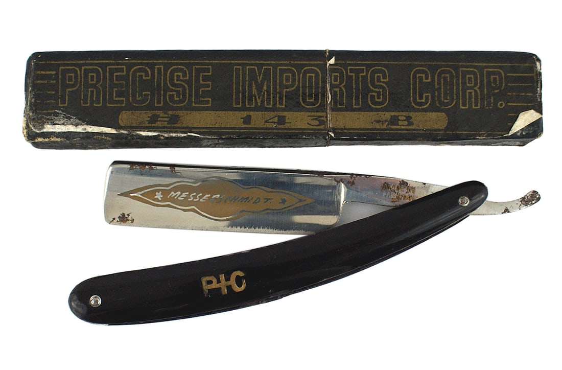 Post WWII copy of a German MESSERSCHIMDT razor: H-148 Post WWII copy of a German "MESSERSCHIMDT" razor. Name on a dull gilt background on bright blade. Tang signed "Made in Pakistan". Some small rust spots on top edge. Plastic handle with inlayed "