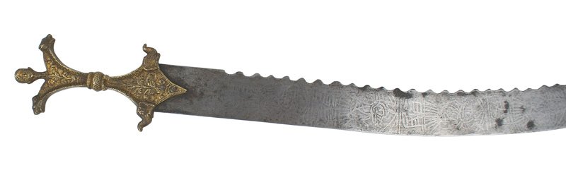 Unusual Indian ceremonial sword 19th Century: R-14 Unusual Indian ceremonial sword one-piece cast brass grip with a narrow center, ram's head shaped upper grip with floral work, tiger heads and a center turbaned head finial. The lower grip is "di