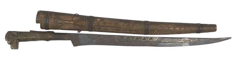Moroccan flyssa Traditional knife of the Kabyles: R-15 Moroccan "flyssa". Traditional knife of the Kabyles. Brass strips applied to the tapered grip and stylized dog head pommel. Narrow curved 11 5/8" blade with incised triangle and brass designs. Fo