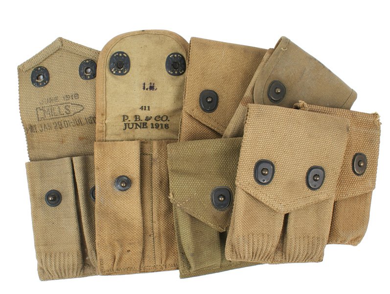 Lot of 7 U.S. 45 cal. magazine pouches WWI II: M-17 Lot of 7 U.S. double webb 45 cal. magazine pouches: (1) WWI - unmarked, 2 with maker and "1918" and 3 "MILLS-1918". (2) WWII - one dated "1943". About II