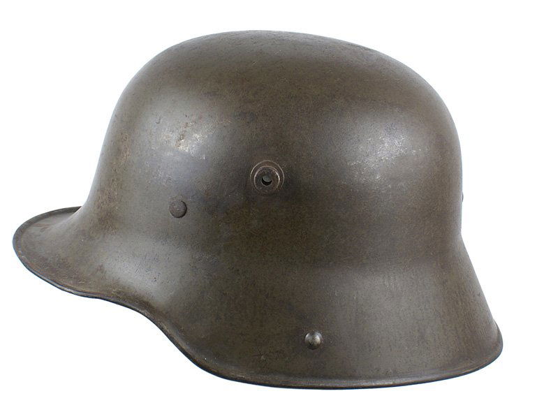 German WWI M1916 helmet: E-13 German WWI M1916 helmet. 60% original green finish. Inner steel liner band and rivets are intact. Missing the 3-section liner, pads, and chinstrap.II