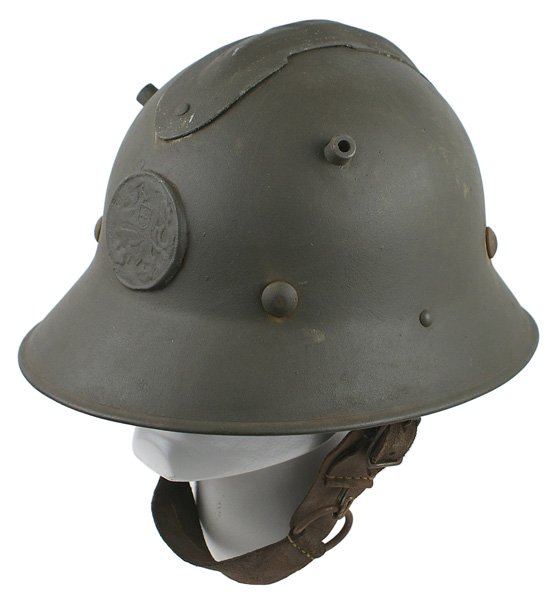 Czech M1926 type helmet similar to German: E-22 Czech M1926 type helmet with a 2 1/4" diameter disc front plate bearing the standing Czech Lion. Also with 2 angled cylinder air vents (similar to the German WWI). Liner consists of 6 black leath