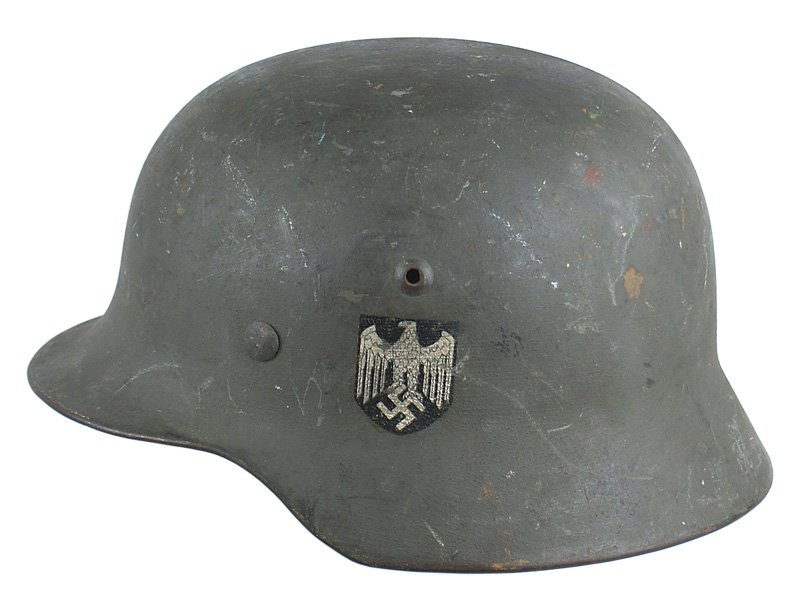 German WWII Army M1935 single decal helmet: E-29 German WWII Army M1935 single decal helmet. Original green painted finish shows scratches and has never been cleaned. Decal would rate 98%. Leather liner and chinstrap show some wear. Overall, a 