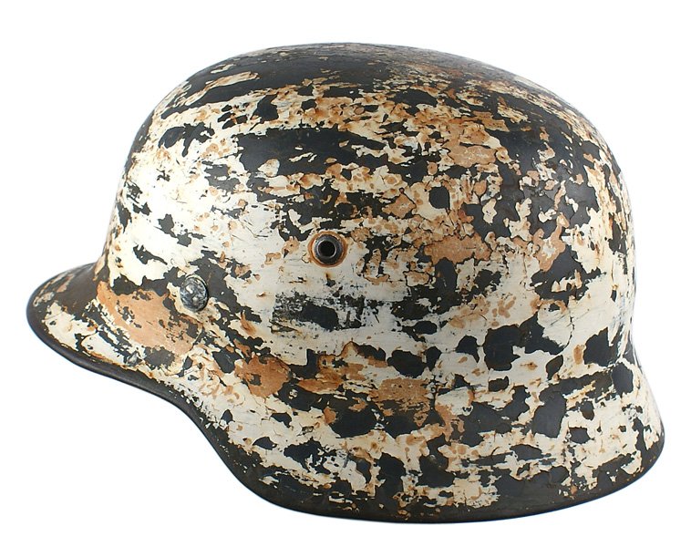 German WWII M1935 winter camo helmet: E-32 German WWII M1935 winter camouflage helmet. A field used helmet which shows the remains of two different white applications. Most of paint is worn from the top and scattered areas. Inside of helm