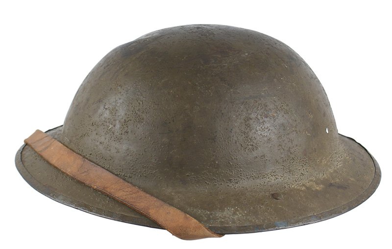 U.S. WWI doughboy helmet: E-80 U.S. WWI "doughboy" helmet. O.D. with some of the original "sand " finish. Bullet dent on top. With liner and chinstrap. About II