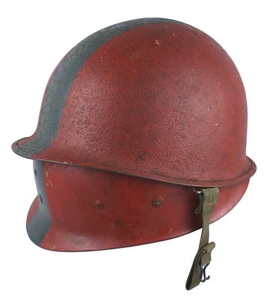U.S. Navy WWII fireman helmet: E-86 Navy WWII fireman's helmet. Standard "sand" finish which has been painted red with a 2" wide blue-gray stripe. Front seam with swivel bales and an O.D. web chinstrap. Matching fiber liner with th