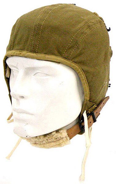 U.S. WWII Type A-9 cloth flight helmet: E-100 U.S. WWII "Type A-9" cloth flight helmet. OD with web strap held small hooks, lamb's wool padded chinstrap and ear covners and white cord ties. With label. Unissued. I