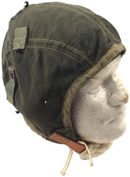 U.S. WWII Type A-9 cloth flight helmet: E-101 U.S. WWII "Type A-9" cloth flight helmet. OD with web strap held small hooks, lamb's wool padded chinstrap and ear covners and white cord ties. With label. Unissued. I