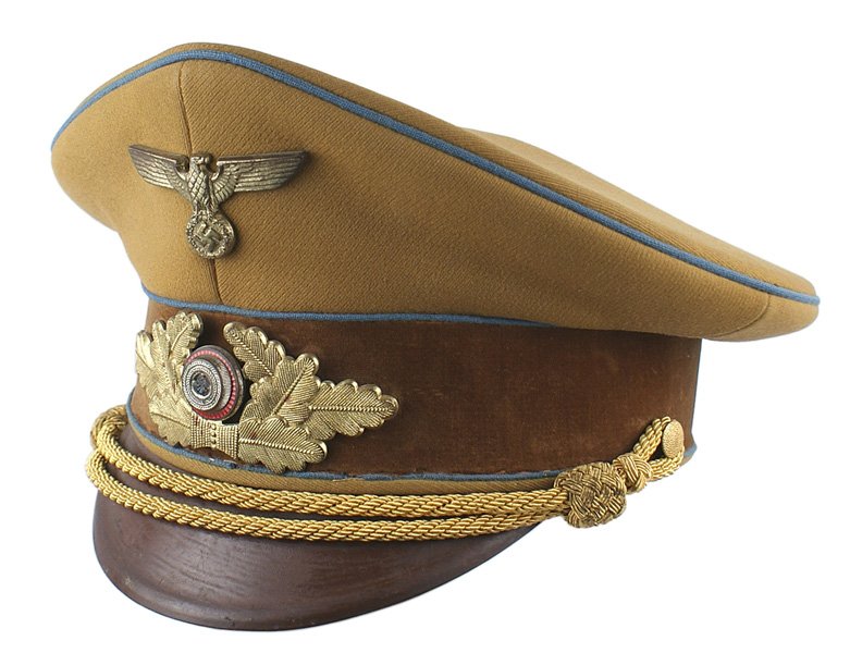 NSDAP Kreisleiter Level peaked cap: E-125 N.S.D.A.P. Kreisleiter. Golden-brown with a brown velvet band and blue piping. Gilt brass long-winged Political type eagle/swastika and long oak leaf wreath with an enameled swastika roundel. Go