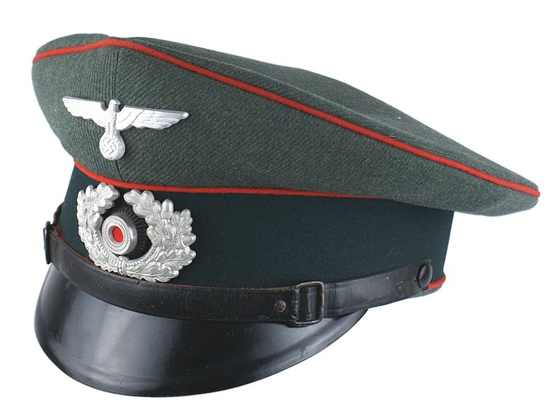 German WWII Artillery EM/NCO peaked cap: E-136 German WWII Artillery EM/NCO peaked cap. Red piped dark green band and feld-grau crown in a ribbed fabric. Silvered metal eagle/swastika and wreath/rosette. Black leather chinstrap and a vulcan 